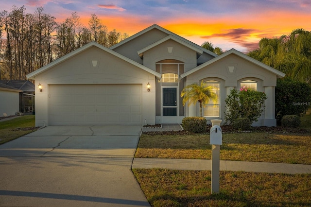 ranch-style home with a yard and a garage