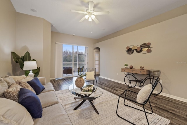 living room with ceiling fan and hardwood / wood-style flooring