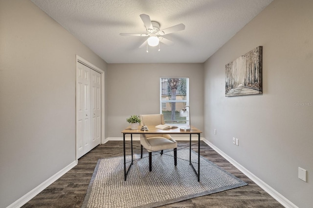 home office featuring ceiling fan, dark hardwood / wood-style flooring, and a textured ceiling