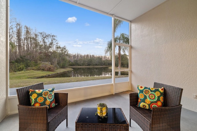 sunroom / solarium with a healthy amount of sunlight and a water view