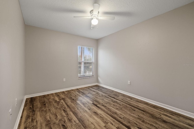 spare room featuring a textured ceiling, ceiling fan, and dark hardwood / wood-style floors