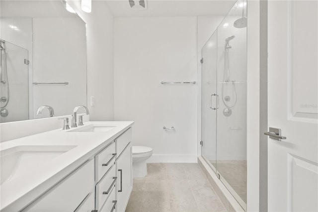 bathroom with a shower with door, vanity, tile patterned floors, and toilet