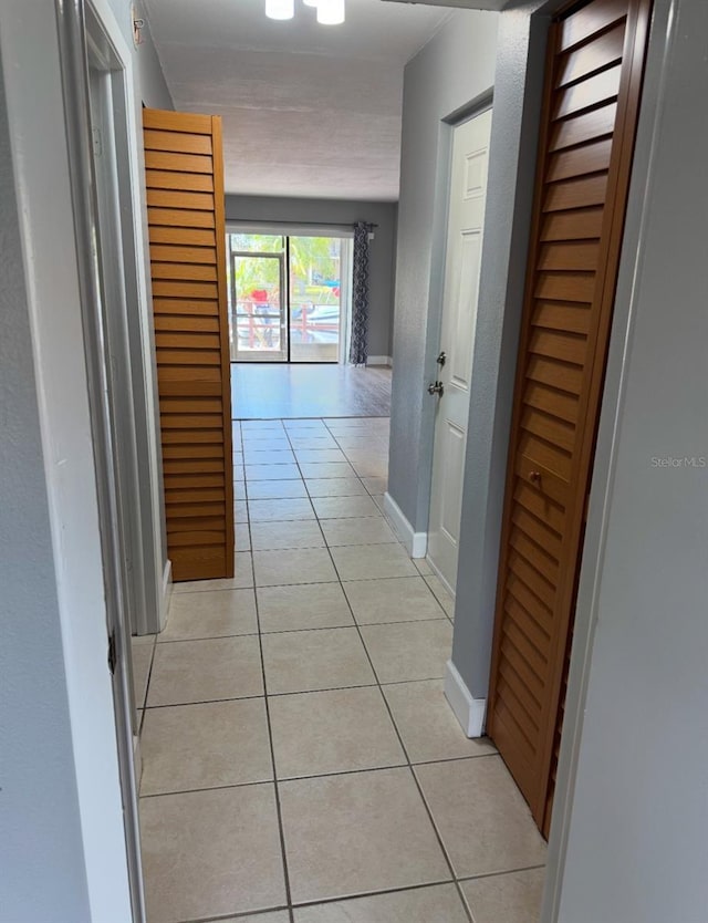 hallway featuring light tile patterned floors