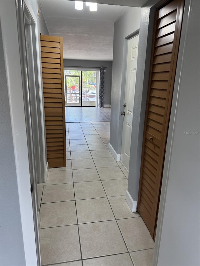 corridor featuring light tile patterned floors