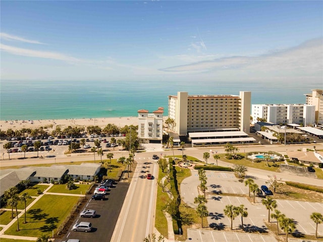 birds eye view of property featuring a water view and a beach view