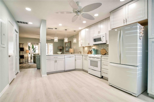 kitchen featuring white appliances, light hardwood / wood-style flooring, white cabinetry, hanging light fixtures, and decorative backsplash