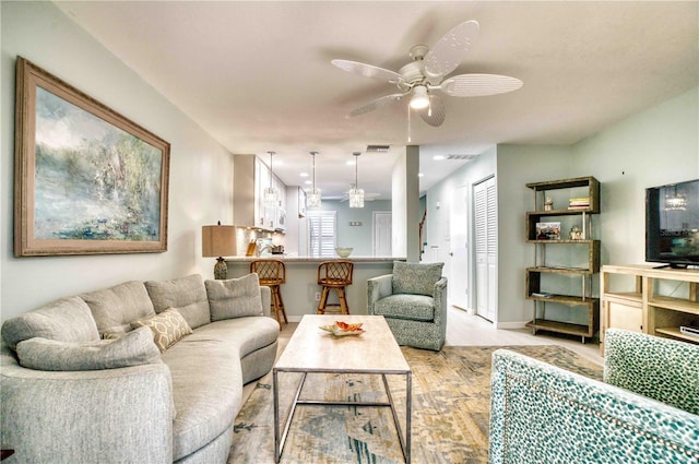 living room featuring ceiling fan and light hardwood / wood-style floors