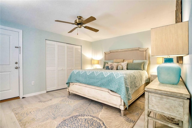 bedroom featuring a closet, ceiling fan, and light wood-type flooring