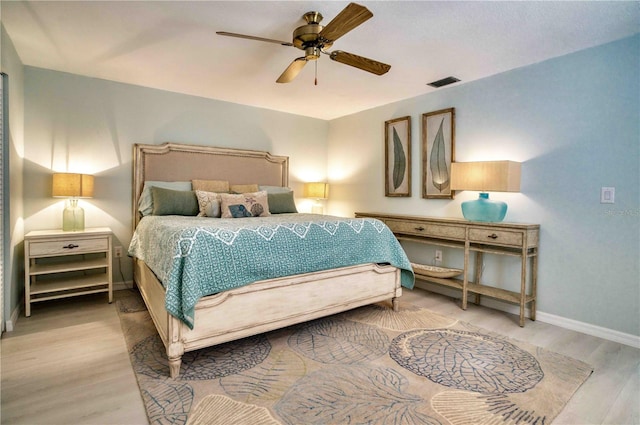 bedroom with light hardwood / wood-style floors and ceiling fan