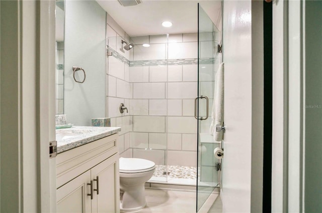 bathroom with vanity, an enclosed shower, and toilet