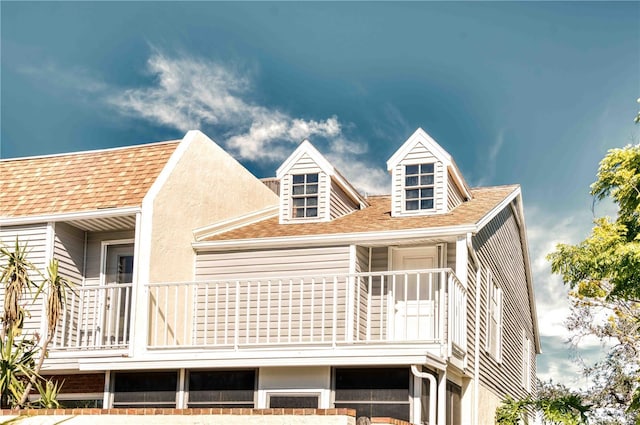 rear view of house featuring a balcony