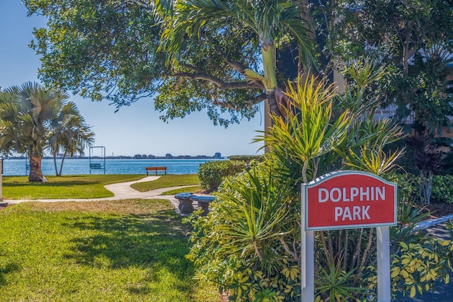 view of community with a yard and a water view