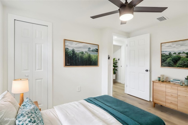 bedroom with a closet, ceiling fan, and light hardwood / wood-style floors