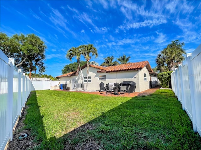 back of property featuring a yard and a patio area