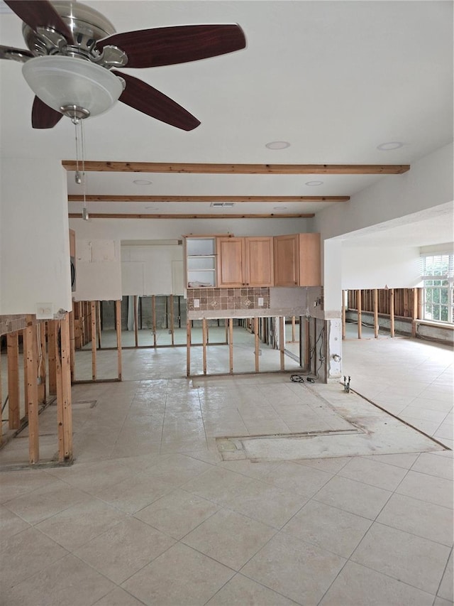 unfurnished room with beam ceiling