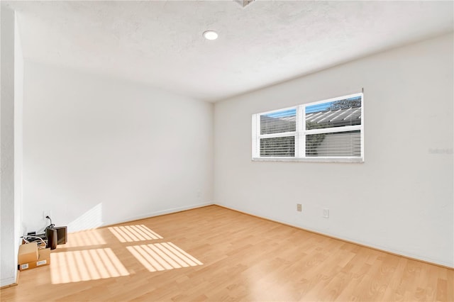 spare room featuring hardwood / wood-style flooring