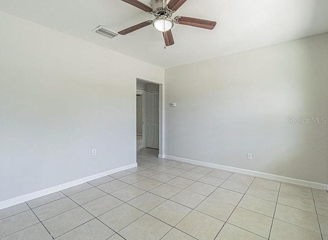 tiled empty room with ceiling fan