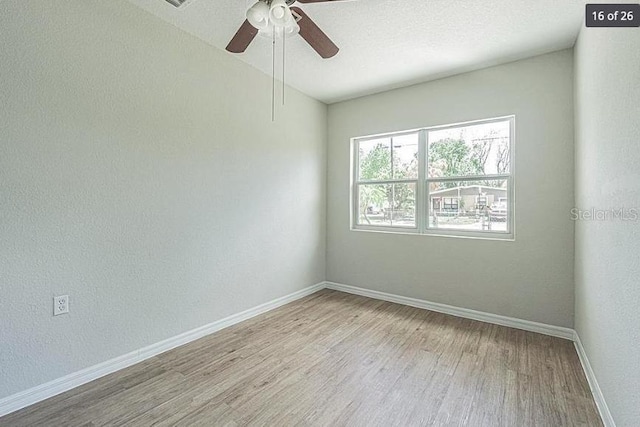 empty room featuring ceiling fan and light hardwood / wood-style flooring