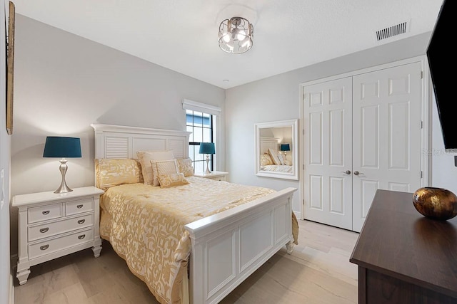 bedroom featuring light wood-type flooring and a closet