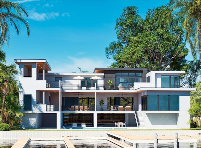 back of house featuring ceiling fan and a balcony