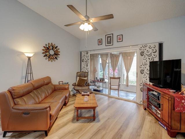 living room featuring lofted ceiling, ceiling fan, and light hardwood / wood-style floors