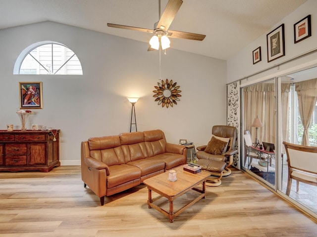 living room featuring a wealth of natural light, light hardwood / wood-style flooring, and lofted ceiling