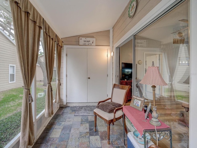 sunroom / solarium featuring vaulted ceiling and plenty of natural light