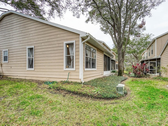 view of property exterior with a lawn