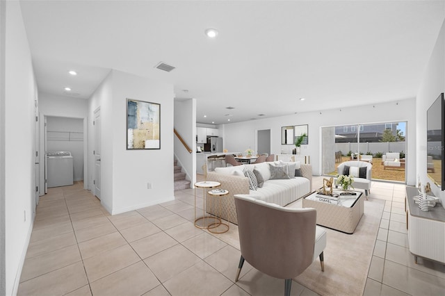 tiled living room with washer / dryer