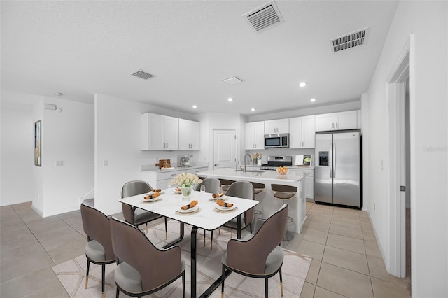 dining room with sink and light tile patterned flooring