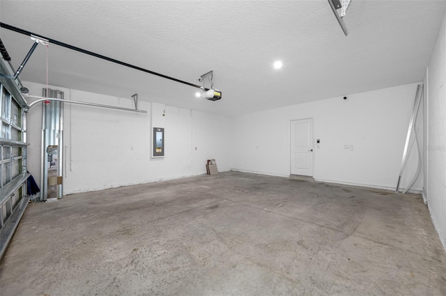 garage featuring electric panel and a garage door opener