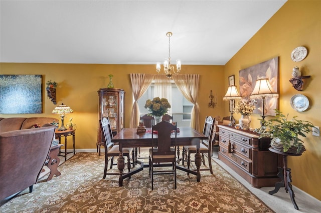 dining room with baseboards, a chandelier, and vaulted ceiling