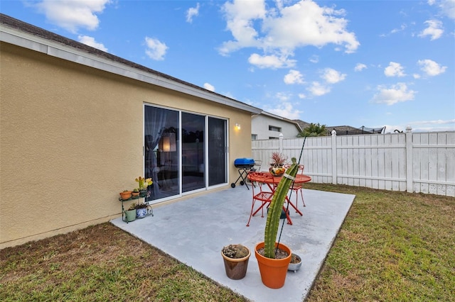 view of patio / terrace featuring a grill and fence