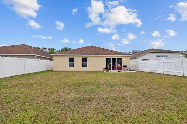 back of property featuring a patio area, a lawn, a fenced backyard, and stucco siding