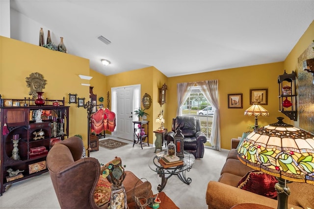 living room featuring lofted ceiling, carpet, and visible vents