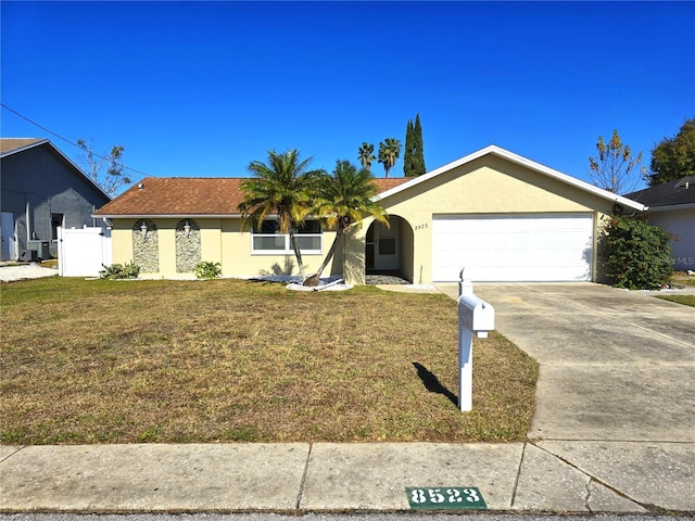 single story home with a front lawn and a garage