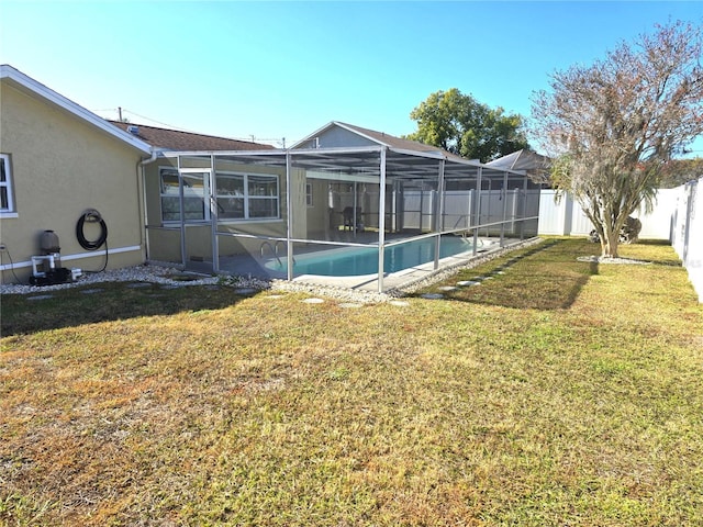 exterior space featuring a lanai, a fenced in pool, and a lawn