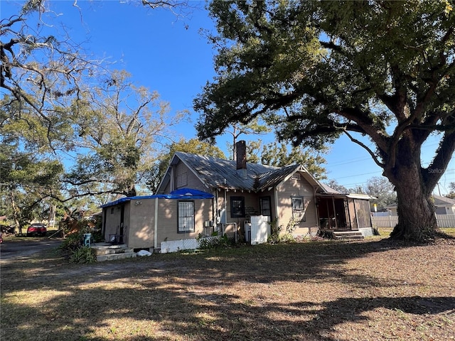 view of side of property with a sunroom