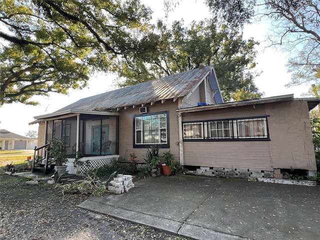 rear view of house with a sunroom