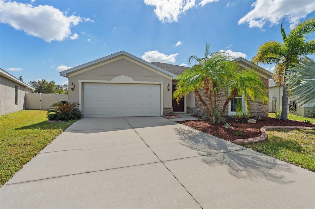 view of front of property with a garage and a front lawn