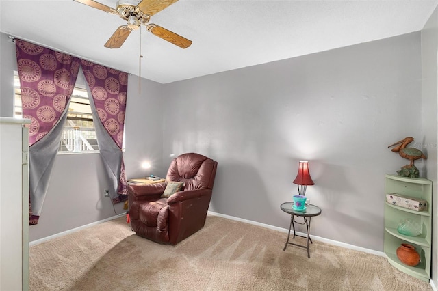 living area with ceiling fan and carpet flooring