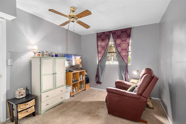 living area with ceiling fan and carpet floors