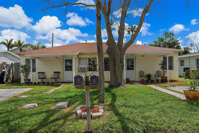 ranch-style home featuring a front yard