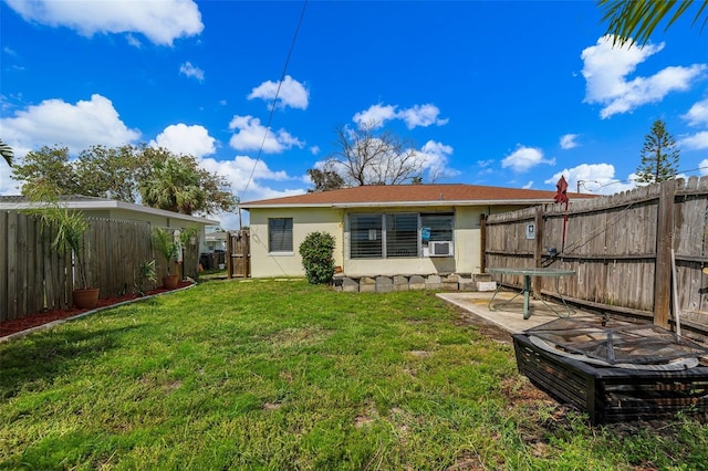 rear view of house with a yard and cooling unit