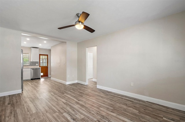 unfurnished living room with ceiling fan and light wood-type flooring