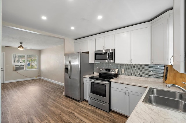 kitchen featuring sink, stainless steel appliances, white cabinets, and ceiling fan