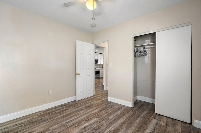 unfurnished bedroom featuring dark hardwood / wood-style flooring, a closet, and ceiling fan