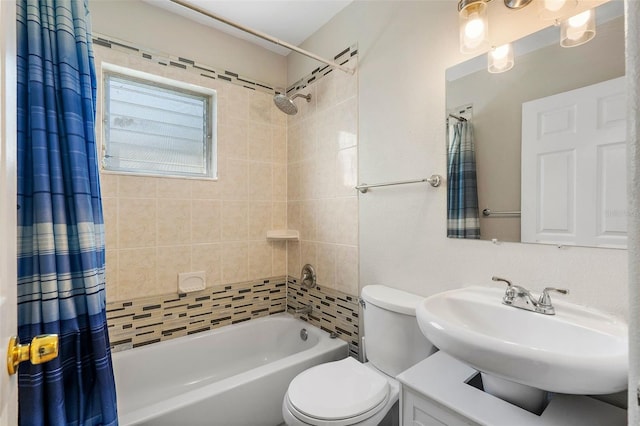 full bathroom with sink, shower / bath combination with curtain, and toilet