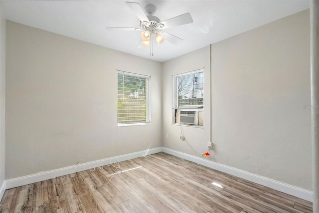 empty room with light hardwood / wood-style floors, ceiling fan, and cooling unit