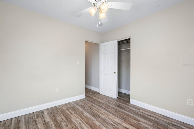 unfurnished bedroom featuring a closet, ceiling fan, and hardwood / wood-style flooring